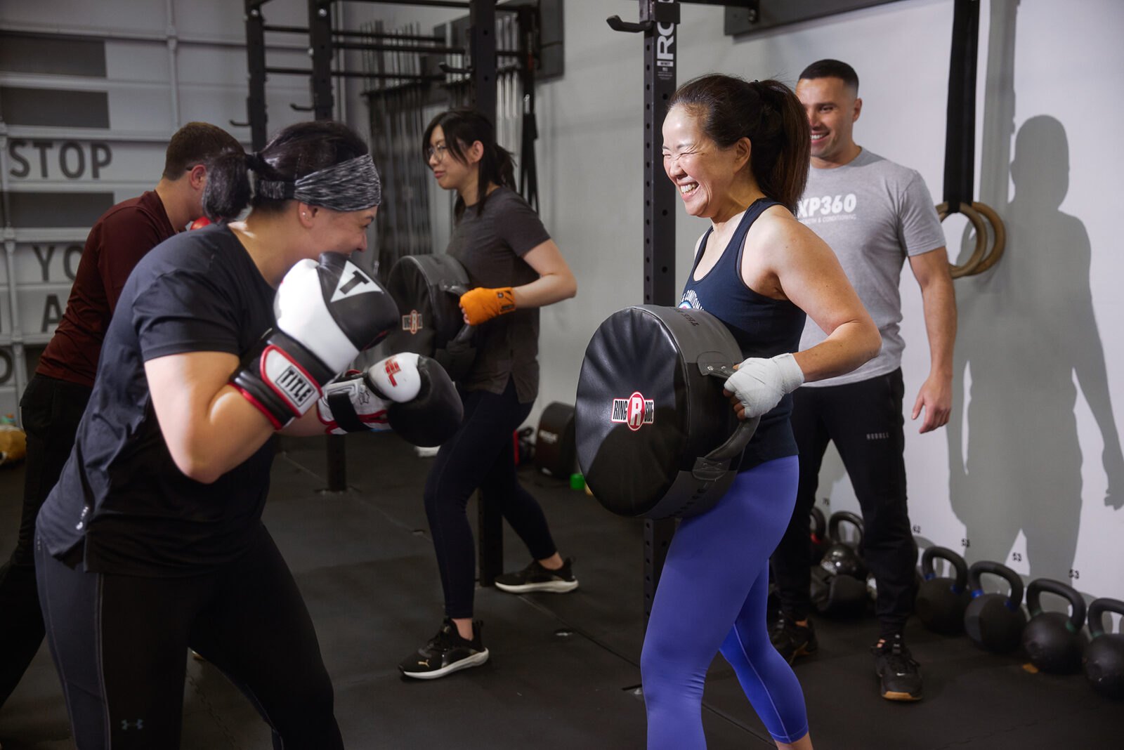 Coach holding mitts for a student practicing punches