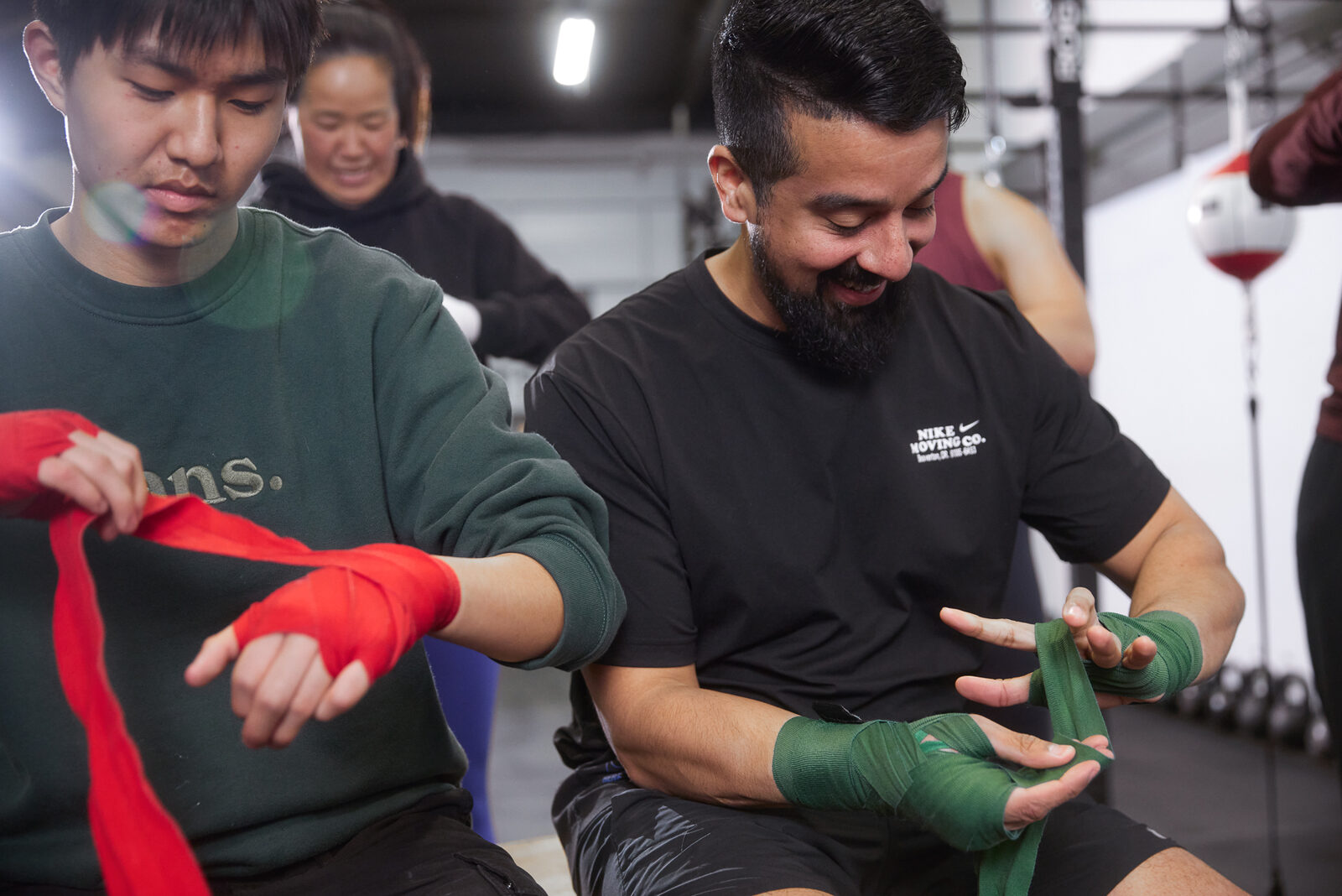 Coach demonstrating boxing stance and hand wrapping